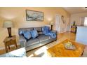 Living room featuring a gray leather couch and wooden coffee table at 7148 Totem Ave, North Port, FL 34291