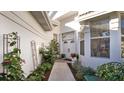Inviting walkway to front door, flanked by lush greenery and wrought-iron accents at 1009 Harbor Town Dr, Venice, FL 34292
