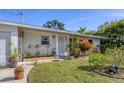 Ranch-style home features a charming front entrance and well-manicured landscaping at 107 Louella Ln, Nokomis, FL 34275