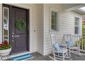 Front porch with rocking chairs and a welcoming wreath at 11678 Aucilla Dr, Venice, FL 34293