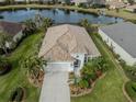 House with a lake view, showcasing the roof and landscaping at 12198 Wakulla Pl, Venice, FL 34293
