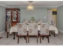Formal dining room with a large table, floral chairs, and a wooden china cabinet at 1300 Indus Rd, Venice, FL 34293