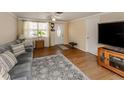 Bright living room with wood-look floors and plenty of natural light at 1300 Indus Rd, Venice, FL 34293