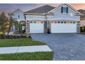 Two-story home with a three car garage and landscaped yard at 13072 Steinhatchee Loop, Venice, FL 34293