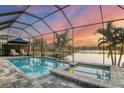 Relaxing pool and spa with lake view and sunset at 13072 Steinhatchee Loop, Venice, FL 34293