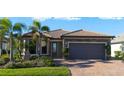 Single story home with a two-car garage and landscaped front yard at 13164 Rinella St, Venice, FL 34293