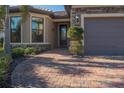 Welcoming front entrance with paver driveway and nicely landscaped at 13164 Rinella St, Venice, FL 34293