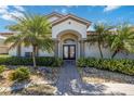 Inviting front entrance with double doors and lush landscaping at 1348 Reserve Dr, Venice, FL 34285