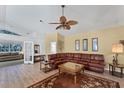 Spacious living room with a large leather sectional sofa and wood flooring at 1384 Clubview Ct, Venice, FL 34292