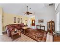 Bright living room featuring a comfortable leather sectional and a ceiling fan at 1384 Clubview Ct, Venice, FL 34292