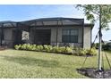 Screened patio with lush landscaping, ideal for outdoor relaxation at 2009 Mackerel St, Port Charlotte, FL 33953