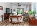 Living room with hardwood floors, comfy furniture, and a fireplace at 201 Auburn Woods Cir, Venice, FL 34292