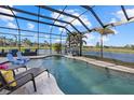 Relaxing pool and lanai area with water view at 20450 Passagio Dr, Venice, FL 34293