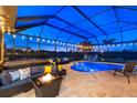 Expansive covered lanai with pool, spa, and fire pit at 20450 Passagio Dr, Venice, FL 34293