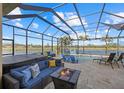 Covered lanai with pool, spa, and fire pit at 20450 Passagio Dr, Venice, FL 34293