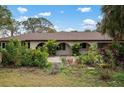 Single-story home with landscaped yard and arched entryway at 2542 Northway Dr, Venice, FL 34292