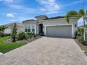 Single-story house with a two-car garage and nicely landscaped front yard at 25509 Royal Tern Ln, Englewood, FL 34223