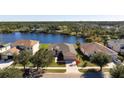 Birds-eye view of a house near a lake in a residential community at 2558 Hobblebrush Dr, North Port, FL 34289