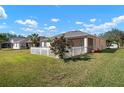 Fenced backyard with a covered patio and well-manicured lawn at 2558 Hobblebrush Dr, North Port, FL 34289