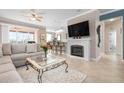 Spacious living room with a fireplace, sectional sofa, and large TV at 2558 Hobblebrush Dr, North Port, FL 34289