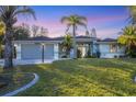 Single-story house with a two-car garage, set on a spacious lot at 2899 Ensenada Ln, North Port, FL 34286