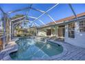 Relaxing kidney-shaped pool with screened enclosure at 2899 Ensenada Ln, North Port, FL 34286