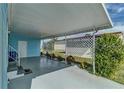 Covered patio featuring lattice, greenery and a view to the backyard at 356 Longwood Dr, Venice, FL 34285