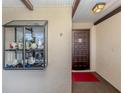 Condo entry with a dark wood door and display case at 380 Three Lakes Ln # F, Venice, FL 34285