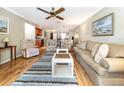 Bright living room with hardwood floors and comfy seating at 380 Three Lakes Ln # F, Venice, FL 34285