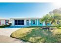 Bright and airy home exterior with a lush green lawn at 411 Circlewood Dr # I2, Venice, FL 34293