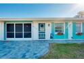 Front view of a house with teal accents and a paved walkway at 411 Circlewood Dr # I2, Venice, FL 34293