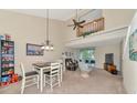 Open concept living space with dining area, kitchen, and balcony access at 4200 Castlebridge Ln # 1924, Sarasota, FL 34238