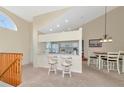 Kitchen with breakfast bar, white cabinets, and adjacent dining area at 4200 Castlebridge Ln # 1924, Sarasota, FL 34238