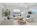 Light and airy living room with neutral decor and comfortable seating at 4575 Cancello Grande Ave, Venice, FL 34293