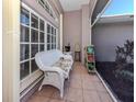 Relaxing screened porch with wicker furniture and potted plants at 498 Lake Of The Woods Dr, Venice, FL 34293