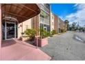 Condo building entrance with covered walkway and planter at 519 Albee Farm Rd # 115, Venice, FL 34285
