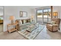 Bright living room with comfy seating and access to balcony at 519 Albee Farm Rd # 115, Venice, FL 34285