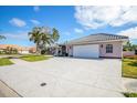 Property's front view showcasing a two-car garage and driveway at 521 Pennyroyal Pl, Venice, FL 34293