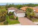 Single-story home with tile roof, driveway, and landscaping at 5592 Semolino St, Nokomis, FL 34275