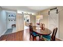 Dining area with barn door leading to kitchen at 649 Tamiami S Trl # 107, Venice, FL 34285