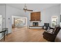 Bright living room featuring a fireplace, sliding glass doors, and hardwood floors at 652 Linden Dr, Englewood, FL 34223