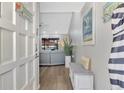 Bright and airy entryway with bench and view to living room at 738 Sorrento Inlt # 738, Nokomis, FL 34275