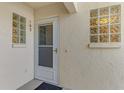 Condo entry with white door and glass block windows at 817 Montrose Dr # 103, Venice, FL 34293