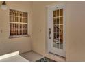 Front entry features a white door and window with a colorful rug at 1006 Gondola Park Dr # 1006, Venice, FL 34292
