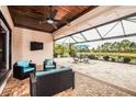 Relaxing covered patio overlooking a lake, perfect for outdoor living at 10319 Medjool Dr, Venice, FL 34293