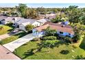 Single-Gathering home with driveway and landscaping nestled in neighborhood at 1237 Schooner Ln, Venice, FL 34285