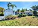 Charming light blue house with a lush green lawn at 1237 Schooner Ln, Venice, FL 34285