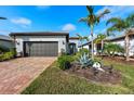 Single-story house with a two-car garage and nicely landscaped yard at 13756 Vadini St, Venice, FL 34293