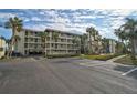 Condo building with parking and landscaping at 1591 Beach Rd # 204, Englewood, FL 34223