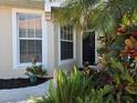 Front entrance with lush landscaping at 1890 San Trovaso Way, Venice, FL 34285
